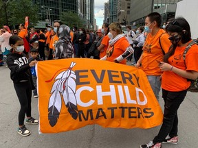 People gather to march in Montreal on Truth and Reconciliation Day, Sept. 30, 2021.