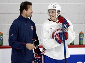 Montreal Canadiens defence prospect Sami Niku speaks with assistant coach Luke Richardson during training camp in Montreal on Sept. 29, 2021.