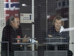 Canadiens general manager Marc Bergevin (right) and assistant GM Scott Mellanby watch the team practice Wednesday during training camp at the Bell Sports Complex in Brossard.
