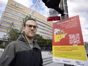 Matis Allali was part of a McGill public policy research team last year that recommended the city move ahead with a long-promised noise observatory. His group's report noted that Montreal lacks a comprehensive noise strategy. Allali stands next to one of 15 signs in the Quartier des spectacles featuring a QR code that stores a questionnaire about the sound environment.