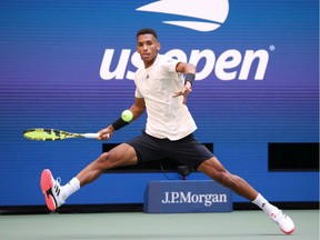 Montreal's Félix Auger-Aliassime lunges to return the ball against Daniil Medvedev of Russia during their Men's Single semifinal match on Day 12 of the 2021 U.S. Open at the USTA Billie Jean King National Tennis Center on Friday, Sept. 10, 2021, in Flushing, N.Y.