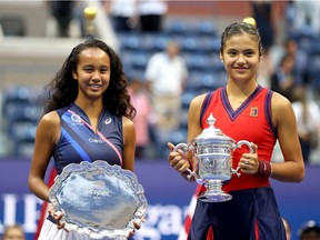 Leylah Annie Fernandez, left, of Canada holds the runner-up trophy as Emma Raducanu of Great Britain celebrates with the championship trophy after their Women's Singles final match on Day 13 of the 2021 U.S. Open on Sept. 11, 2021 in New York City.