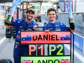 Daniel Ricciardo of Australia and McLaren and Lando Norris of McLaren and Great Britain celebrate finishing 1-2 during the F1 Grand Prix of Italy at Autodromo di Monza on September 12, 2021 in Monza, Italy.