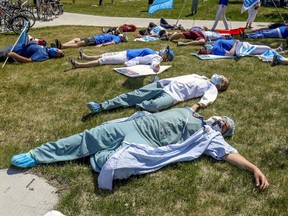 Health care workers held a "die-in" at Maisonneuve-Rosemont Hospital on May 27, 2020 to highlight the exhaustion and burnout of those working in the network.