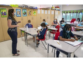 A Grade 3 teacher and students wear masks in class at a Lester B. Pearson School Board elementary school in the West Island oon Thursday, Sept. 9, 2021.