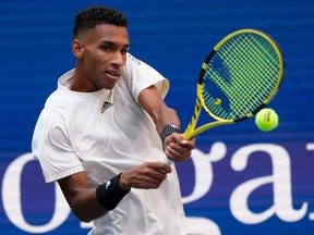 Montreal's Félix Auger-Aliassime hits a return to Russia's Daniil Medvedev during their 2021 U.S. Open Tennis tournament men's semifinal match at the USTA Billie Jean King National Tennis Center in New York on Friday, Sept. 10, 2021.