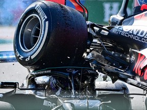 Mercedes' British driver Lewis Hamilton, left, and Red Bull's Dutch driver Max Verstappen collide during the Italian Formula One Grand Prix at the Autodromo Nazionale circuit in Monza, on Sunday, Sept. 12, 2021.