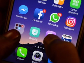 This file photo illustration taken on March 22, 2018 shows apps for Facebook, Instagram, Whatsapp and other social networks on a smartphone in Chennai.