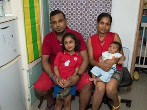 Refugee Supun Thilina Kellapatha (L) holds his daughter Sethumdi with wife Nadeeka Dilrukshi Nonis (R) and their then-2 month old son Dinath.