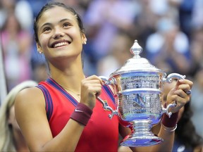 Emma Raducanu of Great Britain celebrates with the championship trophy after her match against Leylah Fernandez of Laval in the women's singles final on Saturday, Sept. 11, 2021, at the U.S. Open tennis tournament at USTA Billie Jean King National Tennis Center in Flushing, N.Y.