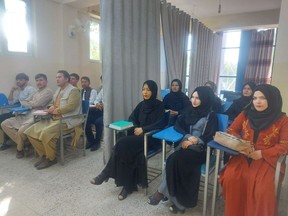 Students attend class under new classroom conditions at Avicenna University in Kabul, Afghanistan Sept. 6, 2021, in this picture obtained by REUTERS from social media.