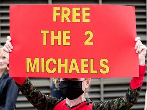 Supporters of Michael Kovrig and Michael Spavor take part in a 5 km walk in Ottawa on Sept. 5, 2021, as the walk marks 1,000 days for for the pair in Chinese prison after Spavor and Kovrig were charged with espionage.