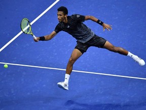 Montreal's Félix Auger-Aliassime hits a return to USA's Frances Tiafoe during their 2021 US Open Tennis tournament men's singles fourth round match at the USTA Billie Jean King National Tennis Center in New York on Sunday, Sept. 5, 2021.