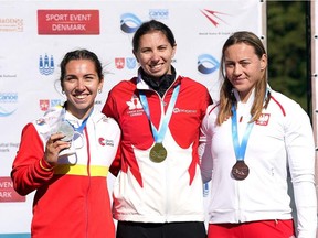 Second place Spain's Antia Jacome, left, first place Canada's Katie Vincent and third place Poland's Dorota Borowska celebrate on the podium after the women's C1 Canoe 200m final of the Canoe and Kayak sprint Worlds Championship 2021 at Bagsvaerd Lake in Copenhagen on Sunday, Sept. 19, 2021.