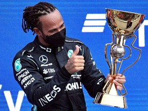 Winner Mercedes' British driver Lewis Hamilton celebrates on the podium after the Formula One Russian Grand Prix at the Sochi Autodrom circuit in Sochi on Sunday, Sept. 26, 2021.