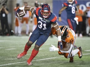 Montreal Alouettes running-back William Stanback breaks away from B.C. Lions' Tim Bonner during first half in Montreal on Sept. 18, 2021.