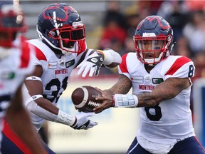 Montreal Alouettes quarterback Vernon Adams Jr. hands off to tailback William Stanback during the first half against the Stampeders in Calgary on Aug. 20, 2021.