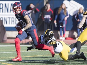 Montreal Alouettes' Dante Absher breaks away from Hamilton Tiger-Cats' Koron Krump during second half in Montreal on Oct. 25, 2019.