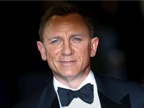 Daniel Craig poses for photographers as he attends the world premiere of the new James Bond  007 film Spectre at the Royal Albert Hall in London on 
Oct. 26, 2015.