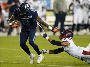 Toronto Argonauts wide receiver Ricky Collins Jr. (2) breaks a tackle from Montreal Alouettes defensive back Patrick Levels (3) after a pass reception during the first half at BMO Field.