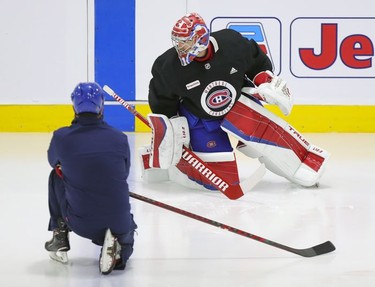 Montreal Canadiens goalie Carey Price does some exercises on the ice under the supervision of a member of the team's training staff at the Bell Sports Complex in Brossard on Thursday, Sept. 16, 2021.