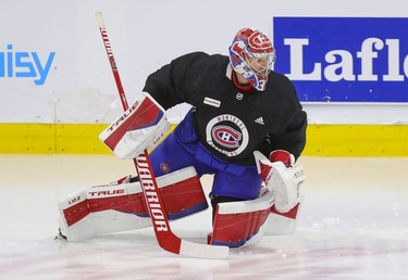 Montreal Canadiens goalie Carey Price does some exercises on the ice under the supervision of a member of the team's training staff at the Bell Sports Complex in Brossard on Thursday, Sept. 16, 2021.