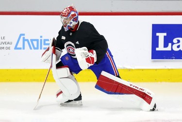 Montreal Canadiens goalie Carey Price does some exercises on the ice under the supervision of a member of the team's training staff at the Bell Sports Complex in Brossard on Thursday, Sept. 16, 2021.