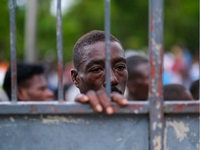 A man affected by the Aug. 14 earthquake waits for food provided by the World Food Programme at a school in Port-Salut, Haiti, on Aug. 24, 2021.