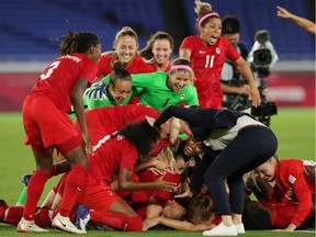 Canada's women's soccer team celebrates winning the penalty shootout and the gold medal at the Tokyo Olympics in Yokohama, Japan, on Aug. 6.