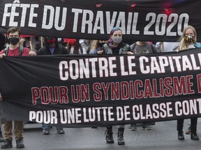People take part in a demonstration on Labour Day in Montreal, Monday, Sept. 7, 2020. "Today Labour Day has lost its meaning for most people. It’s simply a paid day off for almost everyone, perhaps the only holiday with no obligations," Josh Freed writes.