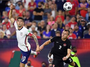 United States midfielder Christian Pulisic (10) heads the ball against Canada defender Alistair Johnston (2) in the first half during a CONCACAF FIFA World Cup Qualifier soccer match at Nissan Stadium in Nashville on Sunday, Sept. 5, 2021.