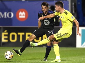 Nashville SC defender Daniel Lovitz (2) kicks the ball against CF Montréal midfielder Mathieu Choiniere (29) during the first half at Saputo Stadium on Saturday, Sept. 11, 2021.