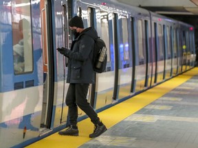 Masked Metro rider gets on a train in Montreal Wednesday January 27, 2021.