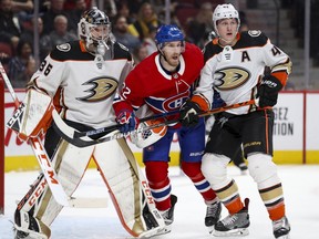 Canadiens' Dale Weise squeezes between Anaheim Ducks' John Gibson, left, and Josh Manson in Montreal on  Feb. 6, 2020.