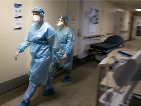 Two nurses do rounds in Verdun Hospital's COVID-19 unit.