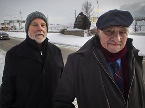 Victor Boyle (left) and Fergus Keyes at the Black Rock on Bridge St. in Montreal on Jan. 19, 2019. Projet Montréal announced Saturday. Oct. 23, 2021,  it's committed to revamping the site around the Black Rock monument.