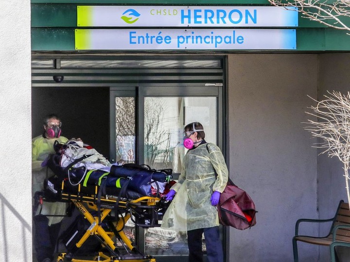  Paramedics wheel a resident out of CHSLD Herron in Dorval on April 8, 2020.