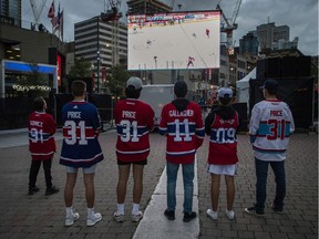 Montreal Canadiens fans watch on big screens at the Quartier des spectacles in Montreal on July 2, 2021, as the Habs took on the Tampa Bay Lightning in Game 3 of the Stanley Cup final.