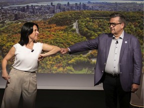 Projet Montréal leader Valérie Plante and Ensemble Montréal leader Denis Coderre share a greeting at the start of a debate by the Montreal Tourism board Sept. 23, 2021.