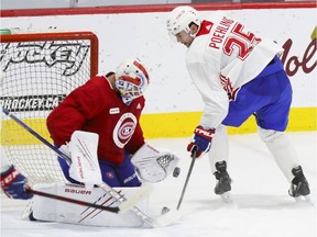 Michael McNiven makes a save against Ryan Poehling during Montreal Canadiens' training camp at the Bell Sports Complex in Brossard on Sept. 28, 2021.