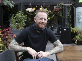 Derek Dammann of the Maison Publique restaurant enjoys the small outdoor terrace on Gilford St. on Tuesday Oct. 5, 2021.