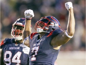 Montreal Alouettes' John Bowman celebrates with Fabian Foote after Bowman sacked Calgary Stampeders' Bo Levi Mitchell during fourth quarter in Montreal on Oct. 5, 2019.