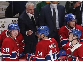 Montreal Canadiens coach Dominique Ducharme talks to his players during a timeout in overtime  in NHL action in Montreal on Thursday October 07, 2021.