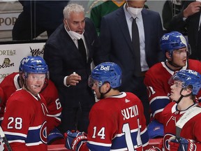 Canadiens coach Dominique Ducharme talks to his players during a timeout in overtime in Montreal on Thursday, Oct. 7, 2021.