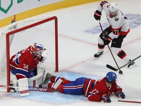 Ottawa Senators' Chris Tierney shoots on Montreal Canadiens goaltender Jake Allen as Alexander Romanov defends during second period in Montreal on Oct. 7, 2021.