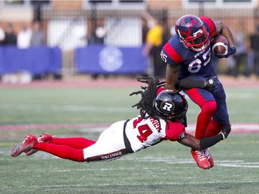 Montreal Alouettes receiver B.J. Cunningham is tackled by Ottawa Redblacks Abdul Kanneh during second half of Canadian Football League game in Montreal Monday October 11, 2021.