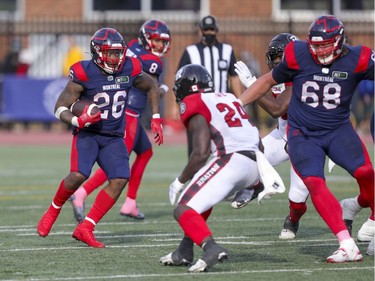 Montreal Alouettes running back Cameron Artis-Payne follows block by offensive lineman David Foucault (right) during Canadian Football League game against the Ottawa Redblacks in Montreal Monday October 11, 2021.