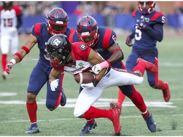 Montreal Alouettes Adarius Pickett tackles Ottawa Redblacks Nate Behar during second half of Canadian Football League game in Montreal Monday October 11, 2021.