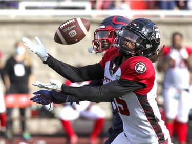 Montreal Alouettes defensive back Rodney Randle Jr., rear, was called for pass interference as he broke up pass intended for Ottawa Redblacks Ryan Davis during Canadian Football League game in Montreal Monday October 11, 2021.