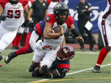 Montreal Alouettes Chris Ackie sacks Ottawa Redblacks quarterback Caleb Evans during Canadian Football League game in Montreal Monday October 11, 2021.